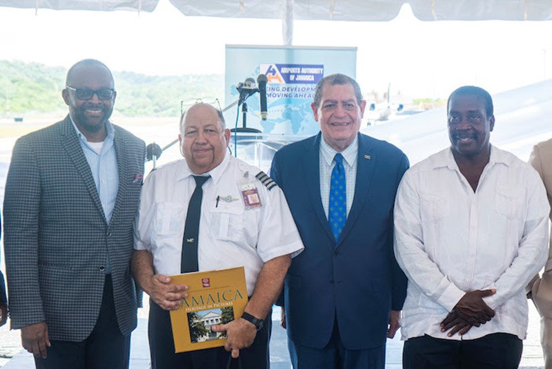 Director of Tourism, Jamaica Tourist Board, Donovan White shares the lens with QCAS Captain Nidio Hernandez, The Honorable Audley Shaw, Minister of Transport and Mining, Jamaica, and the Honorable Robert Montague, Member of Parliament for St. Mary Western, at the Ian Fleming International Airport in Ocho Rios.