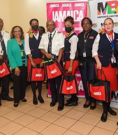Visitor Relations Manager Candessa Cassanova nd Visitor Relations Assistant, Ericka Clarke-Earle, Jamaica Tourist Board, with Cayman Airways Captain Leon Missick (center), Cayman Airways crew members, Regional Airport Operations Manager for Cayman Airways with responsibility for the Caribbean and Latin America Carol Nugent, and representatives from the MBJ Airports Limited at Sangster International Airport in Montego Bay welcoming the first Cayman Airways flight from Grand Cayman to the airport 