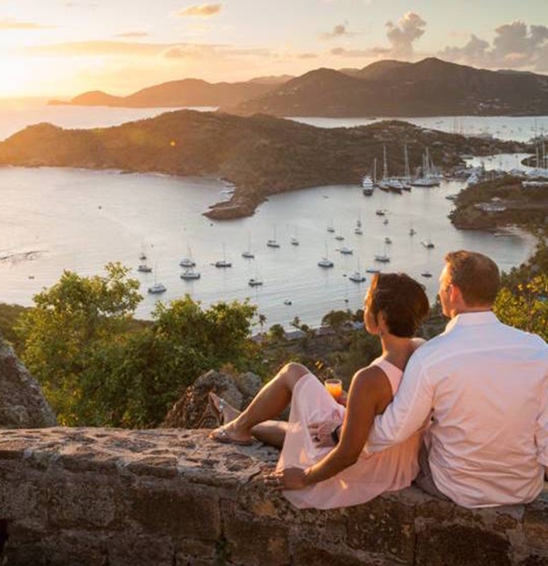 Couple relaxing looking over on Shirley Heights in Antigua