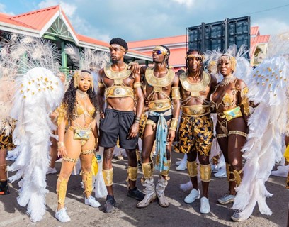Elvis  movie actor Alton Mason (c) and model Tanyka Renee Henry (far right) seen enjoying Antigua Carnival 2022 with friends