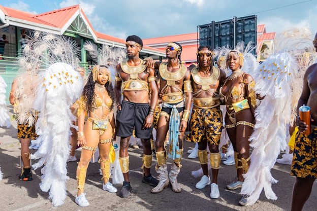 Elvis  movie actor Alton Mason (c) and model Tanyka Renee Henry (far right) seen enjoying Antigua Carnival 2022 with friends