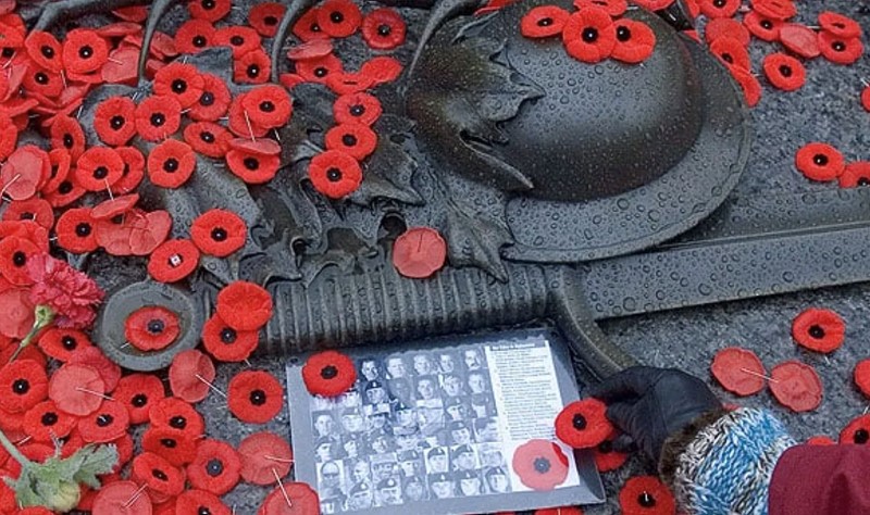 Remembrance Day puppies and soldier hat and sword sculpture 