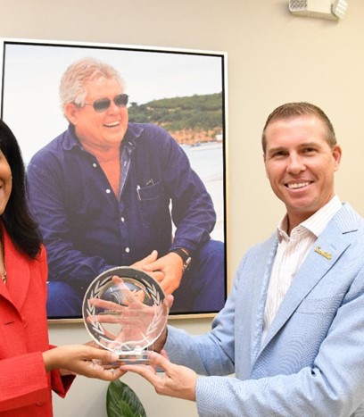 CHTA President Nicola Madden-Greig presents the late Gordon “Butch” Stewart’s Icon of Caribbean Hospitality award to his son Adam Stewart, Executive Chairman, Sandals Resorts International.