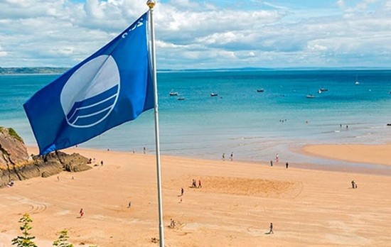 A flag placed on a beautiful sandy beach