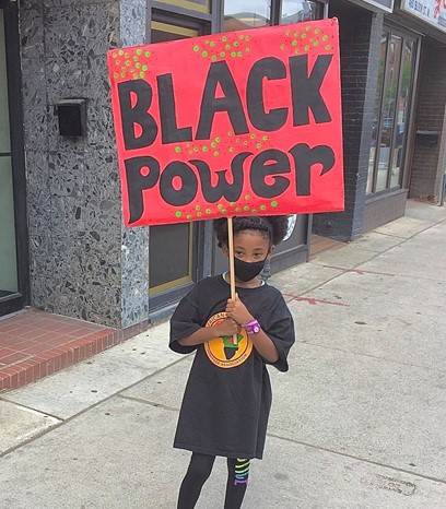 Girl Holding black power placard