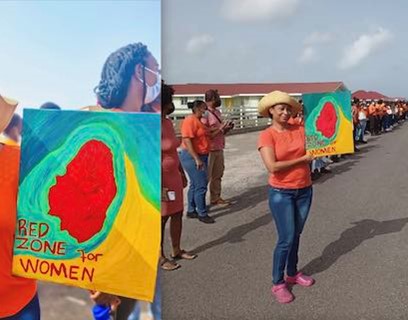 N.C. Mark (L. Don-Tiquila photo) holding protest sign, stands with high school students and staff along the tarmac in front of their school, Arnos Vale, SVG
