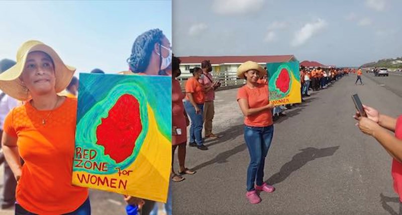 N.C. Mark (L. Don-Tiquila photo) holding protest sign, stands with high school students and staff along the tarmac in front of their school, Arnos Vale, SVG