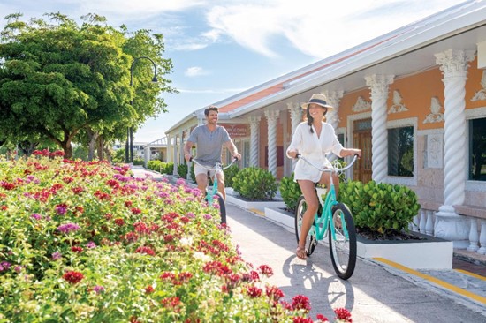 Tourist on bicycle riding in Freeport, Bahamas