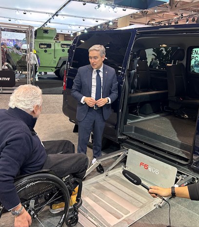 Marco Ferrara, President of Universal Motion, chats with the Hon. François-Philippe Champagne, Minister of Innovation, Science and Industry, at the Canadian International AutoShow about modified vehicles to make driving more accessible. 