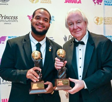 Jameel Rochester, director of tourism at the Anguilla Tourist Board, accepts the 2026 Caribbean’s Leading Culinary Destination and Caribbean’s Leading Luxury Island Destination awards on behalf of Anguilla from World Travel Awards founder Graham Cooke at Princess Grand Jamaica on Oct.