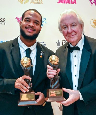 Jameel Rochester, director of tourism at the Anguilla Tourist Board, accepts the 2026 Caribbean’s Leading Culinary Destination and Caribbean’s Leading Luxury Island Destination awards on behalf of Anguilla from World Travel Awards founder Graham Cooke at Princess Grand Jamaica on Oct.
