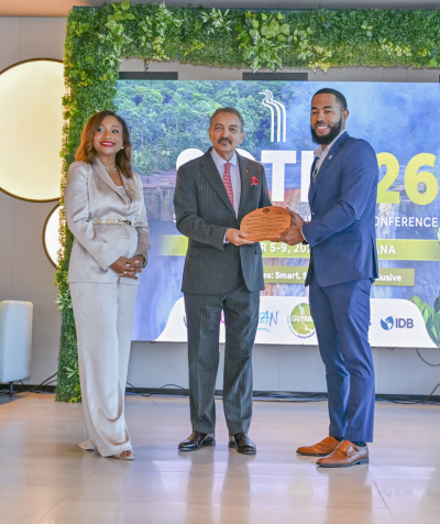 Dr. Dalano DaSouza accepts the tourism intelligence award from CTO Chairman Charles Fernandez, minister of tourism, Antigua and Barbuda, while CTO Secretary-General Dona Regis-Prosper looks on.