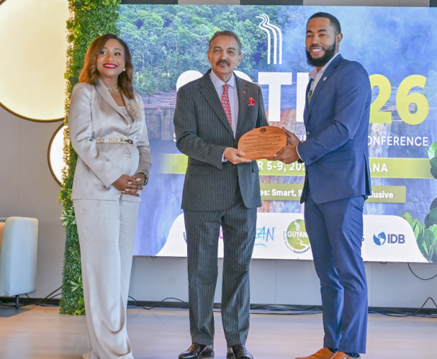 Dr. Dalano DaSouza accepts the tourism intelligence award from CTO Chairman Charles Fernandez, minister of tourism, Antigua and Barbuda, while CTO Secretary-General Dona Regis-Prosper looks on.