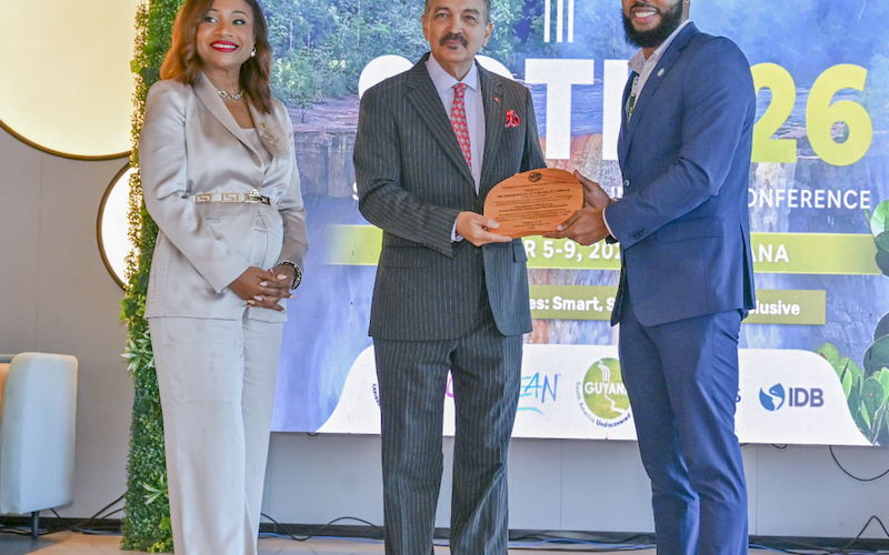 Dr. Dalano DaSouza accepts the tourism intelligence award from CTO Chairman Charles Fernandez, minister of tourism, Antigua and Barbuda, while CTO Secretary-General Dona Regis-Prosper looks on.